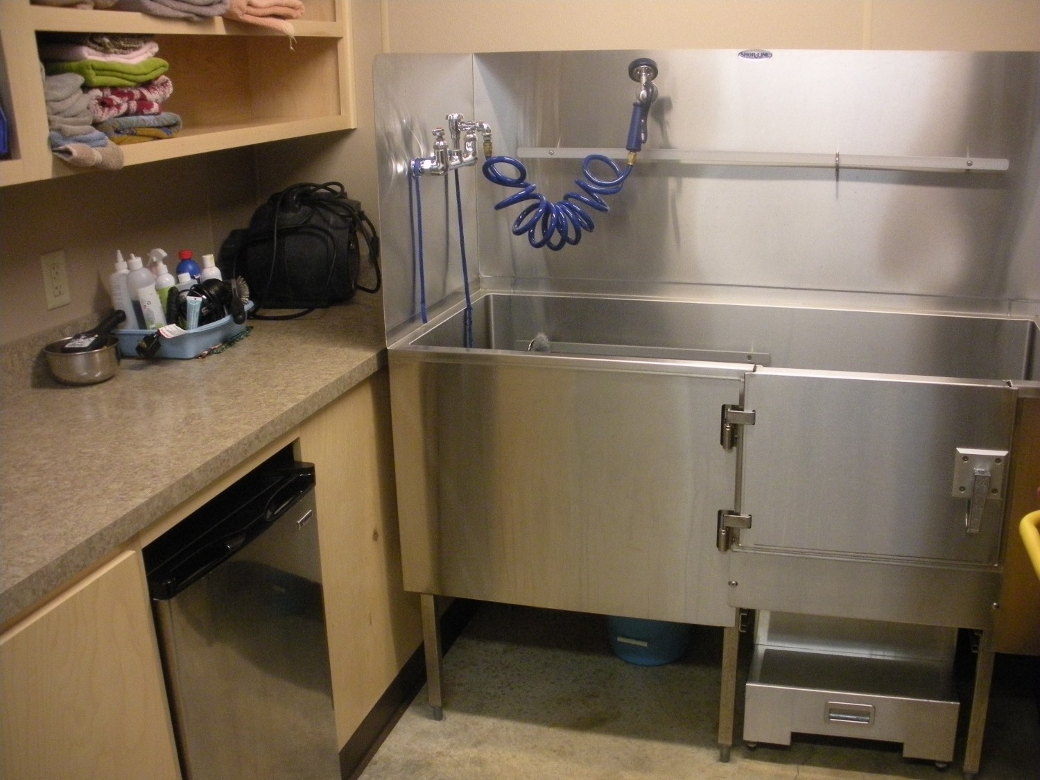 Large stainless steel tub with door and stairs.